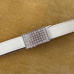 white Nexbelt women's golf belt with a crystal-encrusted buckle.
